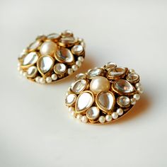 You won't regret investing in this timeless pair of kundan earrings. Inspired from traditional polki jewellery but set in a contemporary arrangement, this pair of stud earrings is gonna give out fashion goals to your peers.  USP: Traditional and Chic. STYLE NOTE: Rock any indo-western outfit with these pearly kundan delights! Keep your jewelry away from water, soap, perfumes and other hard chemicals. If you want to clean it then wipe it gently with the not too wet cloth. SHIPPING: > Import duties and taxes (if any) ARE NOT INCLUDED. Please check the same for your country (especially UK, Europe) before placing the order. ♥SATISFACTION GUARANTEED♥ There is nothing we want more than a happy customer. For us, customer service is top priority. If you have any questions about our jewelry, please Punjabi Wedding Jewelry, Raksha Bandhan Gifts, Jewelry Kundan, Western Outfit, Fashion Goals, Polki Jewellery, Punjabi Wedding, Kundan Earrings, Flower Stud Earrings