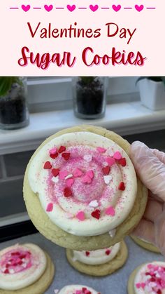 valentine's day sugar cookies with white frosting and pink sprinkles