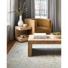 a living room scene with focus on the coffee table and chair in the foreground