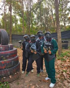 a group of people standing next to each other wearing helmets and holding onto their arms