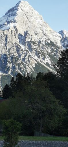 a large snow covered mountain in the distance