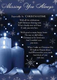 a blue christmas card with two lit candles and snowflakes on the background that says, missing you always