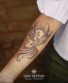 a woman's arm with a bird tattoo on the left side of her arm