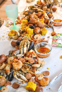 the table is covered with many different types of seafood, including shrimp and mussels