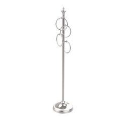 a metal pole with three rings on it and a candle holder in the shape of circles