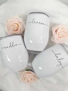 four personalized coffee mugs with roses on the side and name written on them