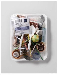 a plastic container filled with lots of different types of scissors and other things in it