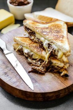 a grilled cheese sandwich cut in half on a cutting board