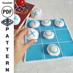 a crocheted board game with balls and letters on it