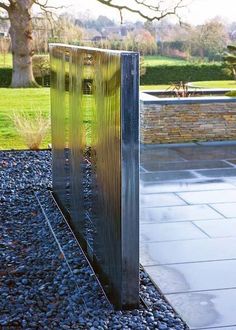 a metal sculpture sitting on top of a gravel field