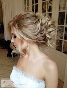 the back of a woman's head with blonde hair styled into a low bun