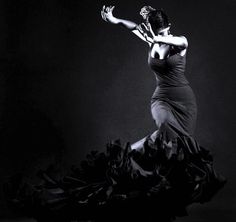 a woman in a long dress is dancing