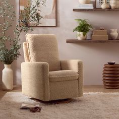 a living room with a chair, vases and pictures on the wall above it