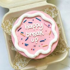 a pink frosted birthday cake with the words happy break up on it