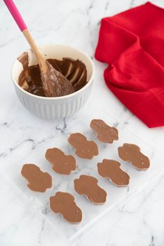 chocolate hearts are being dipped with peanut butter