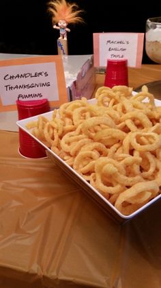 there is a bowl of onion rings on the table