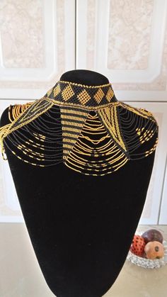 African wedding necklace, Zulu necklace, Beaded shawl necklace, African jewelry, Masai necklace, Bridesmaid necklace, Wedding giftThis stunning necklace is superbly crafted with fine beads.The necklace can be worn with any outfit at different occasions and it will absolutely makes you stand out.100% handmade using fine beads.Closure: ball jointColor: gold and black.3-5 days delivery via DHL ExpressThe shipping fee is for the first item only and additional necklaces or items ship for free.Wholesa Masai Necklace, Zulu Necklace, Beaded Shawl, African Woven Basket, Egyptian Fashion, African Beads Necklace, Body Necklace, Cowrie Shell Necklace, Necklace African