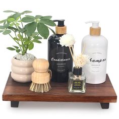 a wooden table topped with bottles and plants