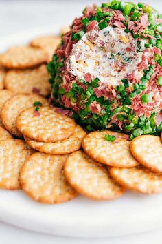 a white plate topped with crackers covered in food