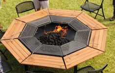 a fire pit sitting on top of a wooden table