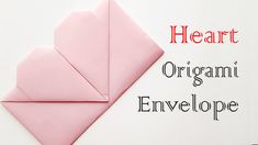 an origami envelope made out of pink paper with the words heart on it