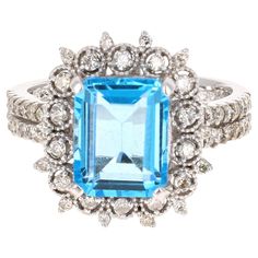 This beautiful Emerald cut Blue Topaz and Diamond ring has a stunning 4.07 Carat Blue Topaz and its surrounded by 56 Round Cut Diamonds that weigh 0.46 Carats. The total carat weight of the ring is 4.53 Carats. The setting is crafted in 14K White Gold and weighs approximately 6.4 grams. The ring size is 7 and can be re-sized free of charge, if needed. Cushion Cut Wedding Rings, Gold Diamond Wedding Rings, Sapphire Cocktail Ring, Gold Cocktail Ring, Best Engagement Rings, Blue Sapphire Diamond, Aquamarine Jewelry, Diamond Cocktail Rings, Rings Cool