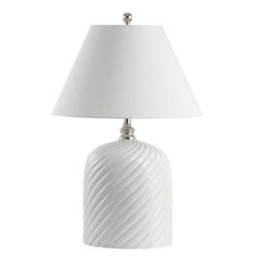 a white table lamp with a white shade on it