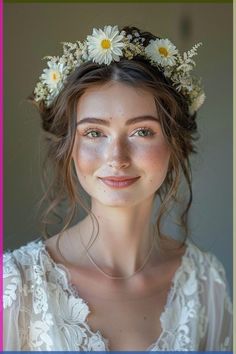 a woman with flowers in her hair wearing a white dress and smiling at the camera