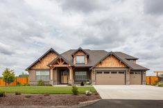 a large house with two car garages on the front and one story above it