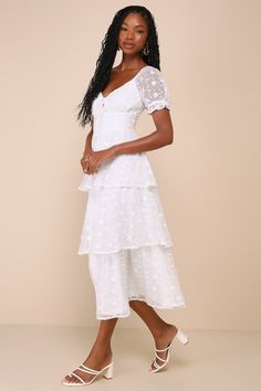 The Lulus Precious Sweetie White Embroidered Midi Dress will be your favorite way to look effortlessly cute all season long! Airy woven chiffon, adorned with white floral embroidery throughout, shapes sheer puff sleeves (with elastic at the shoulders and cuffs), a sweetheart neckline, and lightly gathered cups with a dainty tie-front detail and cute keyhole cutout at the center. The flattering set-in waist sits atop a tiered, A-line skirt that skims the figure as it falls to a chic midi hem. Smo Flowy Floral Embroidered Midi Dress For Brunch, Summer Tiered Dresses With Floral Embroidery, Feminine Swiss Dot Dress For Garden Party, White Swiss Dot Dresses For Spring, White Chiffon Midi Dress For Spring, Feminine Swiss Dot Dress For Brunch, White Chiffon Dress With Lace Trim, Summer Wedding Dress With Swiss Dot Details, Summer Swiss Dot Wedding Dress