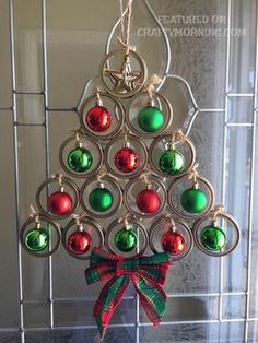 a christmas ornament hanging from a glass rack with baubles on it