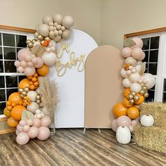 an arch made out of balloons and some hay