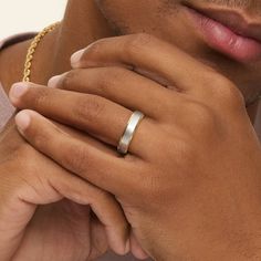 a close up of a person wearing a gold ring