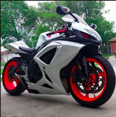 a white and red motorcycle parked on the street