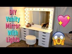 a vanity mirror with lights and stool in a room