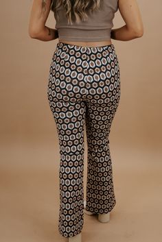 Take me back in time, this 70's inspired pant is featured in a true-to-size fit with a wide-leg style bottom and slimming high-waisted design. Radiate pure retro energy! Waist: High-rise elasticized Fabric: 100% Polyester Wide leg style botto Abstract design throughout Imported Fit: True to size!- Waist: High rise- Leg: Wide - Has some stretchModel Specs: Emily is wearing a size small in the photo.How will this item fit you? Check out our MODEL SPECS(Typical Sizing - Karli: S-Size 5/26 - 5ft 2in, Emily: S-Size 3/25 - 5ft 5in, Syd: L/XL- Size 15/ - 5ft 8in)﻿Need help with sizing? No problem! Join our VIP group on Facebook, Everyday Chic Boutique VIP Insiders to chat directly with our team and other customers just like you.Packaged with love and shipped from our warehouse in Wilmington, Ohio Retro Non-stretch High-waisted Pants, Retro Flare Bottoms For Fall, Retro Stretch High-waisted Pants, Retro Flare Pants For Fall, 70s Inspired Fitted Wide Leg Bottoms, 70s Inspired Fitted Straight Leg Bottoms, Retro Spring Flares, Retro Fitted Wide Leg Bottoms, Retro Stretch Straight Leg Pants