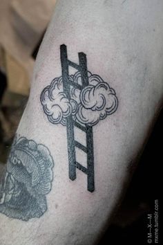 a man with a tattoo on his arm has a ladder to the sky and clouds