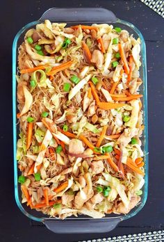 a casserole dish with shredded carrots, meat and veggies in it