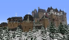 a very large castle in the middle of a snowy forest with lots of snow on it