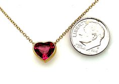 This gorgeous heart-shaped pink rubellite tourmaline necklace is simply dazzling! It features a 1.99 carat striking gem with vivid hot pink color, set in a custom-made 18k yellow gold bezel and suspended on a classic and elegant 18k yellow gold chain. The pendant measures approximately 3/8" in diameter, and the necklace can be adjusted from 16.5 to 18 inches for wonderful versatility! Stunning for both daytime and evening wear. What better way to show your affection than with this timeless expre Heart-shaped Jewelry With Bezel Setting For Valentine's Day, Heart-shaped Bezel Set Jewelry For Valentine's Day, Fine Jewelry With Bezel Setting For Valentine's Day, Valentine's Day Jewelry With Bezel Setting, Bezel Necklace, Rubellite Tourmaline, Hot Pink Color, Tourmaline Necklace, Yellow Gold Chain