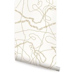 a white and gold wallpaper with an abstract design on the back side of it