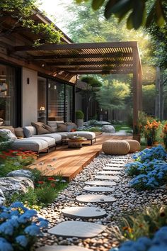 an outdoor living area with flowers and rocks