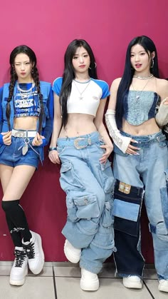 three girls standing next to each other in front of a pink wall with their hands on their hipss