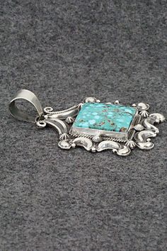 This stunning natural Kingman turquoise and sterling silver pendant was made by Navajo silversmith Derrick Gordon. The back is signed Derrick and stamped Sterling.Length: 2 7/8"Width: 2"Free shipping on all orders! We ship with USPS and always include tracking. All orders ship within a day of payment.Returns are accepted up to 30 days after you receive your order. Just send us a message. Our shop offers cash back or store credit. The item must be returned in new condition. Southwestern Engraved Turquoise Necklace, Engraved Southwestern Turquoise Necklace, Sterling Silver Turquoise Necklace With Concho, Kingman Turquoise, Holiday Sales, Sterling Silver Pendant, Sterling Silver Pendants, Silver Pendant, Turquoise