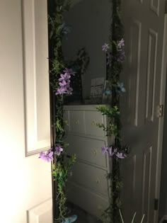 an open door with purple flowers on it