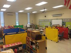 an empty classroom filled with lots of desks and bookshelves covered in yellow tarps