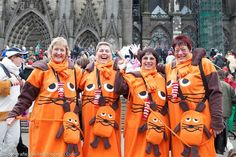 some people in costumes are posing for a photo outside the cathedral with their hands on their hipss