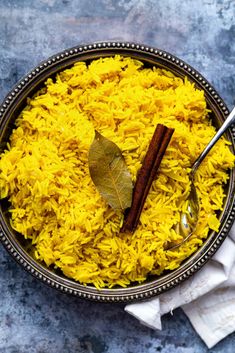 a bowl filled with yellow rice and spices