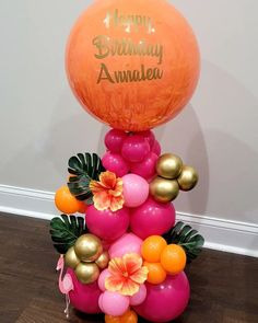 an orange and pink balloon with flowers on it