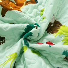 a close up view of a blanket with flowers on it's edges and an animal design